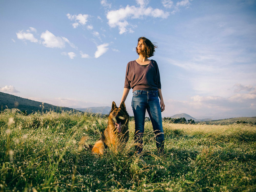 mujer y perro en el campo