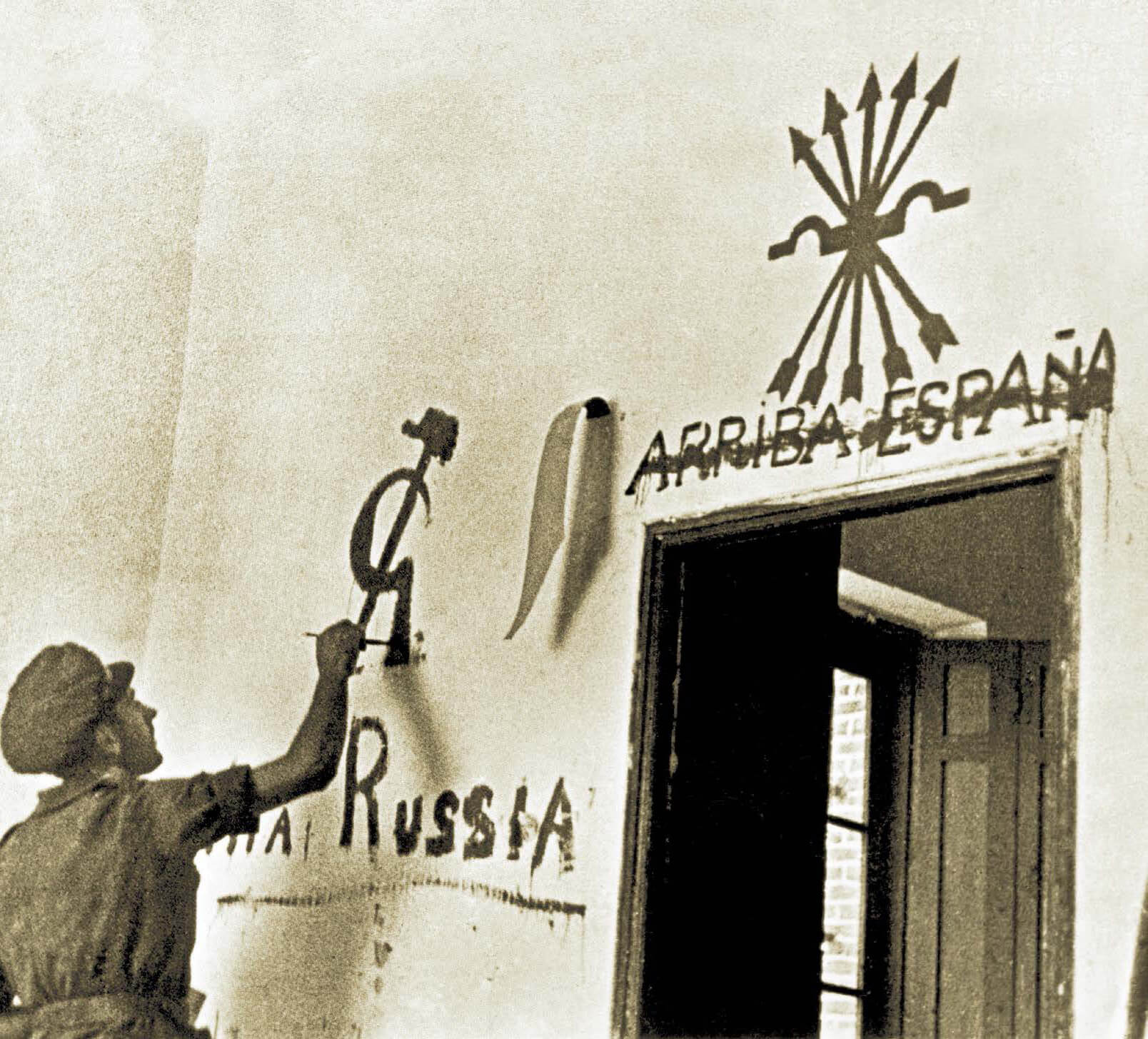 Un soldado pinta una hoz y un martillo en Brunete