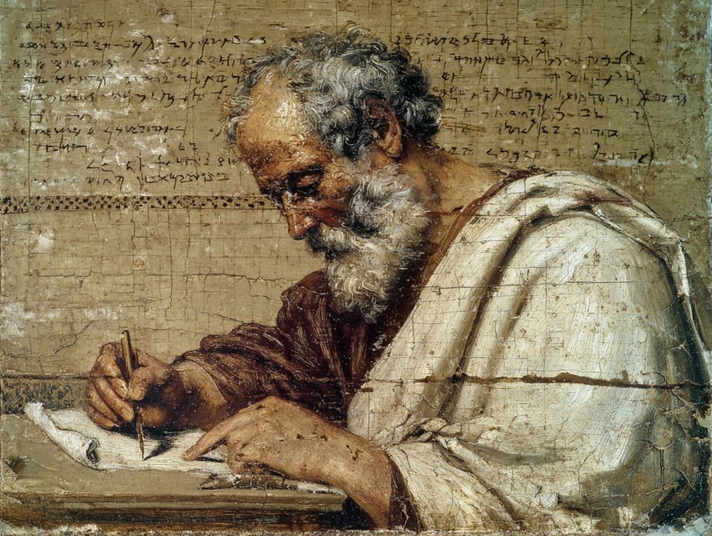 Hombre de la antigüedad escribiendo un papiro