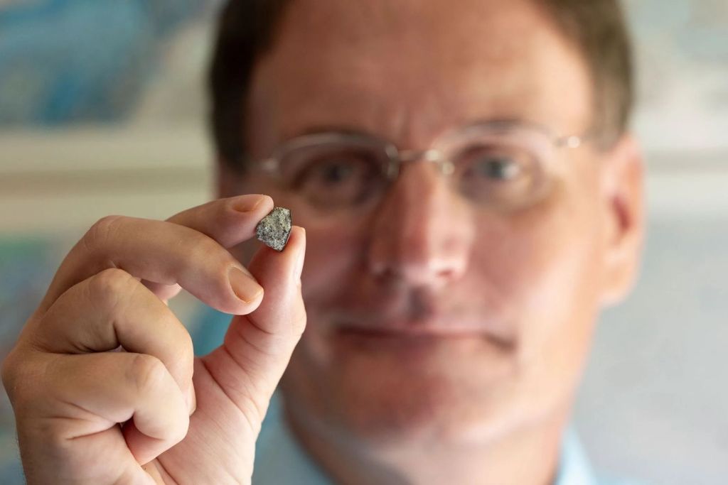 El investigador de la Universidad de Georgia, Scott Harris, sostiene en sus manos un fragmento del meteorito McDonough